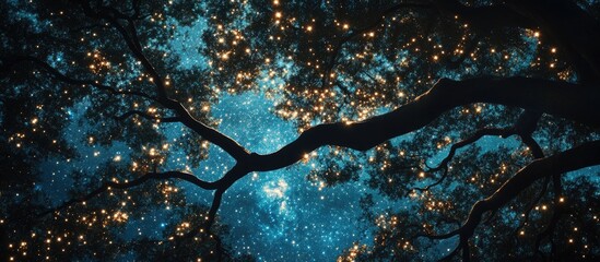 Poster - Silhouetted dark tree branches with vibrant green leaves against a luminous blue starry night sky twinkling with bright golden stars.