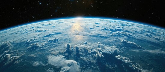 Poster - Vibrant blue earth illuminated by sunlight with wispy white clouds beneath a deep starry night sky featuring a radiant moon above the horizon