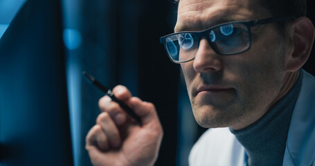 Poster - Portrait of a Neurosurgeon Examining Brain Scans on Computer Screen, Focusing on Healthcare Science and Medicine. Glasses Reflect Medical Images and Neurological Data
