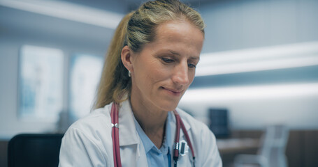 Aufkleber - Portrait of a Caucasian Female Physician Working in Hospital Office, Looking Down on a Computer Screen with a Gentle Smile