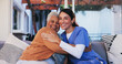© peopleimages.com - Old woman, nurse and portrait with hug on sofa for healthcare support, medical service and bonding together. Retirement home, caregiver and senior person with embrace, homecare and happy for recovery