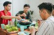 © Gatot - Portrait Of Young Friends Cooking Korean Barbeque Together