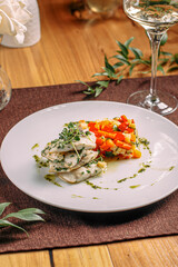 Wall Mural - Portion of gourmet white fish with sauted vegetables