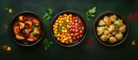 Canvas Print - Delicious chicken hearts in a dark bowl, vibrant chickpeas in a colorful bowl, and tender dumplings in another bowl against a dark green background.