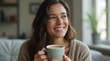 © Prasitama - close up portrait of a smiling young Caucasian woman enjoying the aroma of fresh coffee at home while relaxing and enjoying the day