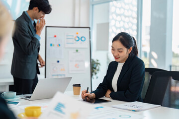 Wall Mural - focused business professional taking notes during a financial presentation in a modern office enviro