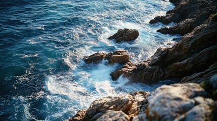 Wall Mural - A view of the ocean from the top of a cliff, perfect for use in coastal-themed designs or to represent a sense of freedom and adventure