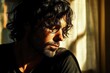 © julija - contemplative portrait of man with flowing dark hair against sunlit window, moody chiaroscuro lighting, ethereal atmospheric glow, artistic composition