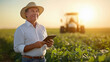 © PRASANNAPIX - middle aged agronomist holding tablet in the field