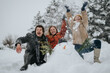 © qunica.com - A group of friends having fun on a snowy day, engaging with nature through playful activities like building a snowman and enjoying the outdoors in a festive winter setting.