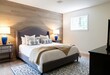 © dedy - Modern bedroom sanctuary with wooden accent wall and calming color palette