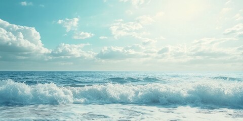 Wall Mural - A serene ocean view with gentle waves under a bright blue sky and soft clouds.
