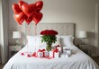 © rfassets - Romantic Valentine's Day bedroom with red heart balloons, roses and gifts on a white bed