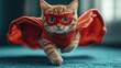 © Denys - Ginger kitten in superhero costume sprinting confidently, embodying playful heroic spirit