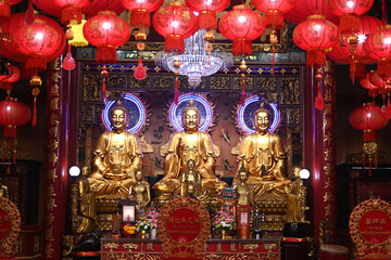 Wall Mural - Three beautiful golden Buddha sculptures are decorated inside Wat Mangkon Kamalawat (Dragon Temple) in Bangkok's Chinatown.