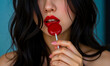 © Celt Studio - Sensual woman with red lips holding large red lollipop closeup beauty portrait female lips close up candy sweet treat
