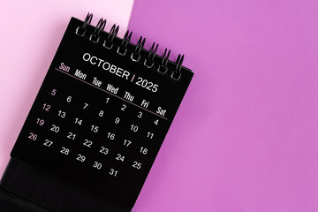 Wall Mural - October black desk calendar for 2025 year on purple background.