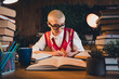 © deagreez - Young student with short blond hair writing notes at home, focusing on exam preparation in a cozy interior with casual style
