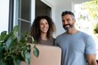 © Milos - A joyful couple stands at the front door, smiling and holding a package, portraying the excitement of receiving a delivery in a bright, modern home setting.