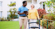 © peopleimages.com - Caregiver, happy and tablet with old woman and walker for rehabilitation, healthcare report or support plan. Medical, advice and nurse with person with a disability outdoors for elderly care