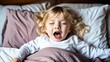 © RulArt - funny face expression with open mouth of blonde caucasian three years old child, sleeping on king bed