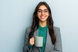 © InfinitePhoto - young woman in smart business attire smiles while holding coffee mug, exuding confidence and professionalism