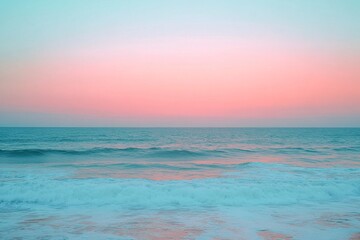 Wall Mural - Vibrant pink and blue sky reflecting over calm ocean waves at dusk near the shoreline