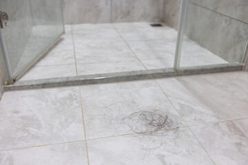 Wall Mural - Bathroom floor with loose hair strands