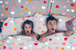 © deagreez - What we did last night Top view of funny man and woman lying in bed covered by sheets with wide opened eyes and mouth looking at camera, having shock, confuse