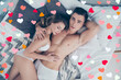 © deagreez - Top view of sexy husband and wife, relaxing in bed, woman sleeping on her lover shoulder, attractive, dreamy man holding hand behind the head looking at camera, honey moon