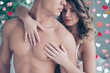 © deagreez - Cropped portrait of half face profile naked torso man and charming woman with hairstyle embracing his lover from back, holding hands on chest with serious expression looking at camera on valentine day