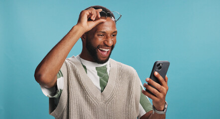 Bonus, phone and surprise with black man in studio isolated on blue background for alert or announcement. Excited, reaction and wow with winner African person reading text message for promotion