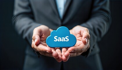 person carefully holding a cloud icon with the word saas written on it, representing software as a s