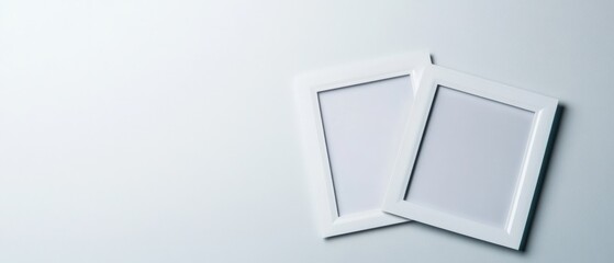 two blank white square picture frames on a minimalist white background