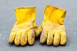 © Priya - a pair of dirty yellow work gloves on the ground