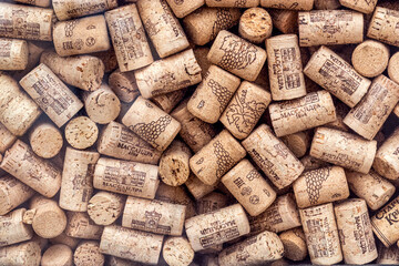 Used wine corks, background. Corks have Massandra brand name. Decor in window of wine shop, view from street. Many used wine corks. - Evpatoria, Crimea, January 26, 2025