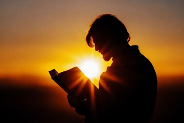 silhouette of a man holding a bible at sunrise, seeking spiritual guidance and reflection in the warm glow of sunlight