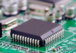 © ADDICTIVE STOCK - Close-up view of a microchip on a green circuit board