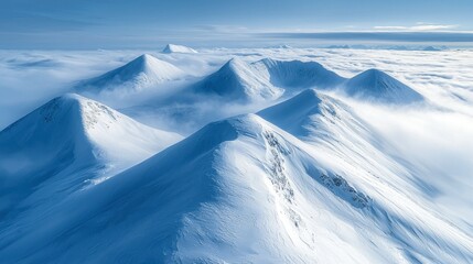 Wall Mural - Snowy mountain peaks above clouds, aerial winter landscape