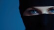 © Дмитрий Першин - Mysterious gaze: close-up of eyes with black veil against blue background