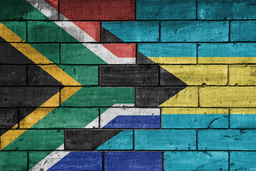 Wall Mural - colourful painted big flag of south africa and flag of bahamas on a massive old brick wall background. concept