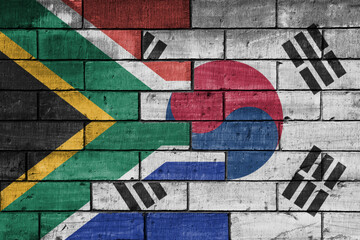 Sticker - colourful painted big flag of south africa and flag of south korea on a massive old brick wall background. concept