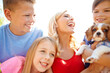 © peopleimages.com - Woman, children and excited outdoor with dog, new family pet and pleased for adoption approval. Mother, happy kids or puppy in backyard for bonding, fun or responsibility on summer holiday with laugh