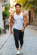 © kvladimirv - Fit Young Man Jogging in Urban Street with Determined Expression and Stylish Outfit