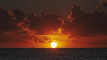 Wall Mural - vibrant sunset over ocean with dramatic clouds at dusk, 4k