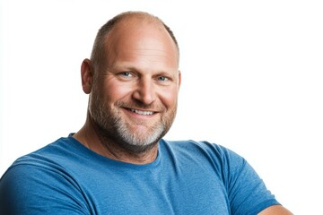 Wall Mural - Smiling caucasian bald male adult in blue t-shirt posing against white background