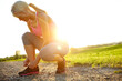 © peopleimages.com - Woman, fitness and tying shoes with sunshine on dirt road in nature for workout preparation or running in countryside. Active, female person or runner tie laces with sneakers for cardio or exercise