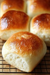 Wall Mural - Golden Brown Crusty Baked Bread Rolls Cooling On Rack