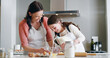 © peopleimages.com - Mother, girl and baking with milk, kitchen and learning with ingredients for pastry and dessert or bread. Happy, woman and daughter help teaching for cooking pudding, cake or bakery recipe in house