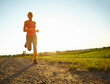 © peopleimages.com - Fitness, woman and running at outdoor space for cardio training, exercise and morning routine in nature. Below, runner and workout at sky mockup for marathon preparation, healthy body and challenge